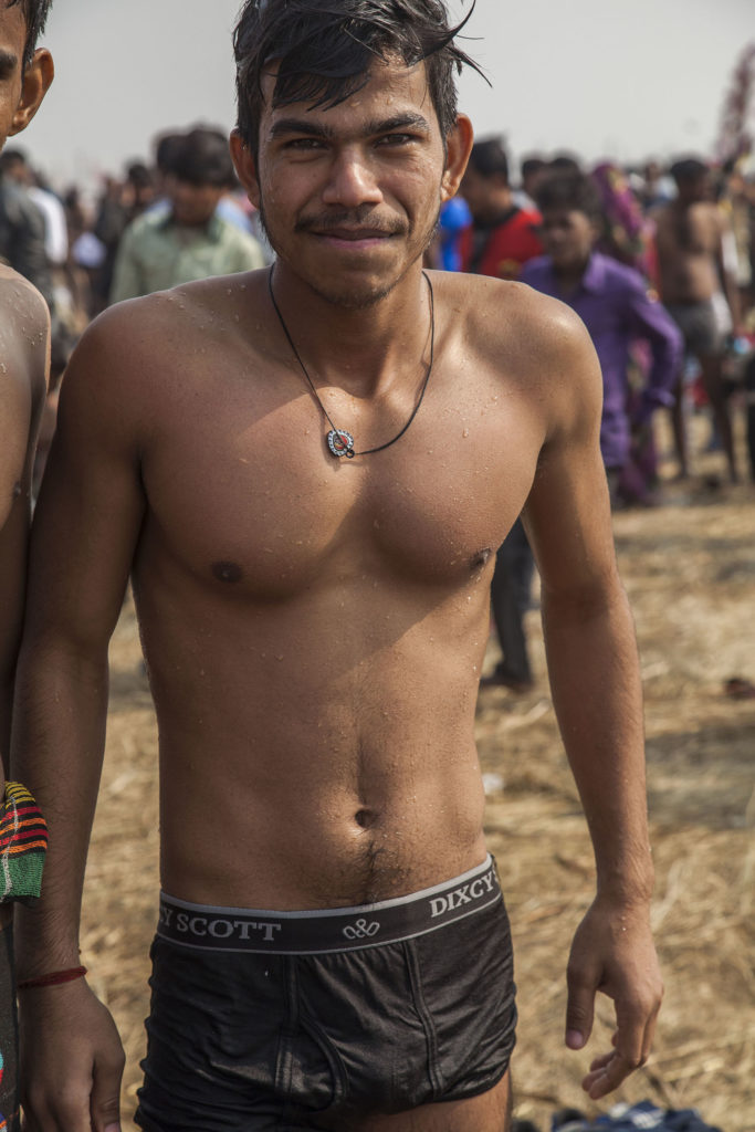 A shirtless Indian man in underwear by the Ganges at Marg Melah in Allahabad India