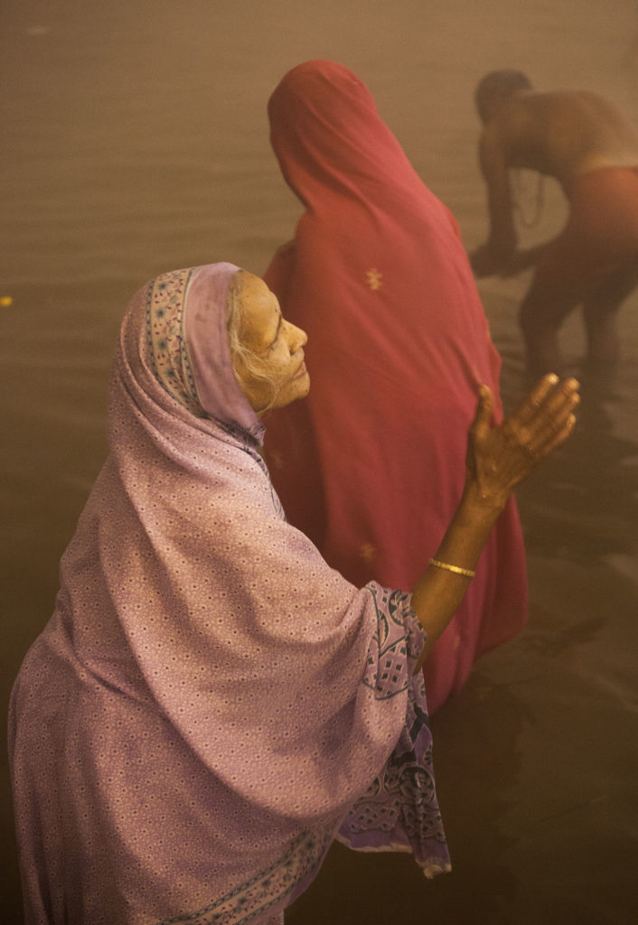 Elderly Indian woman swimming in the Ganges at Marg Melah Allahabad India