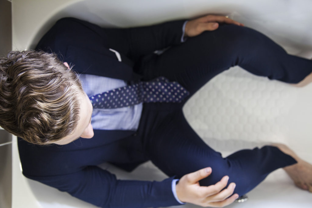 Jesse in a suit in a bathtub