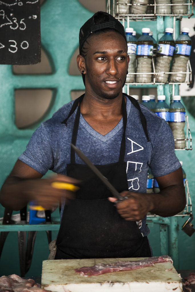 A Cuban butcher sharpening his knife in a butcher shop in Havana Cuba