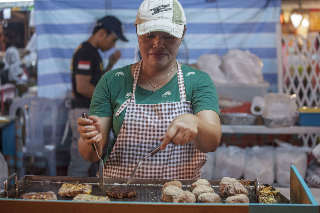 Bruneian woman cooking at night market in Bandar Seri Begawan Brunei Darussalam