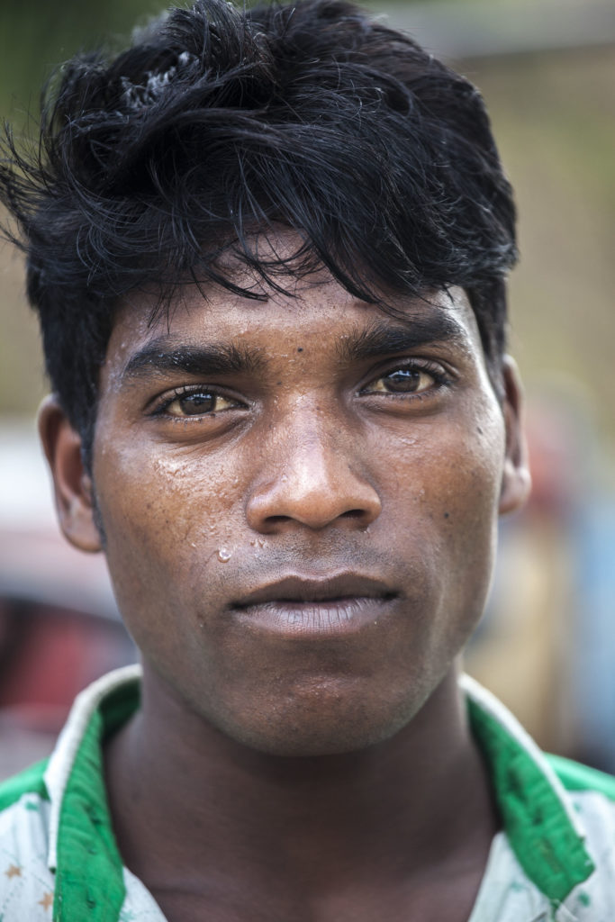 Indian man working at tea plantation in Srimangal