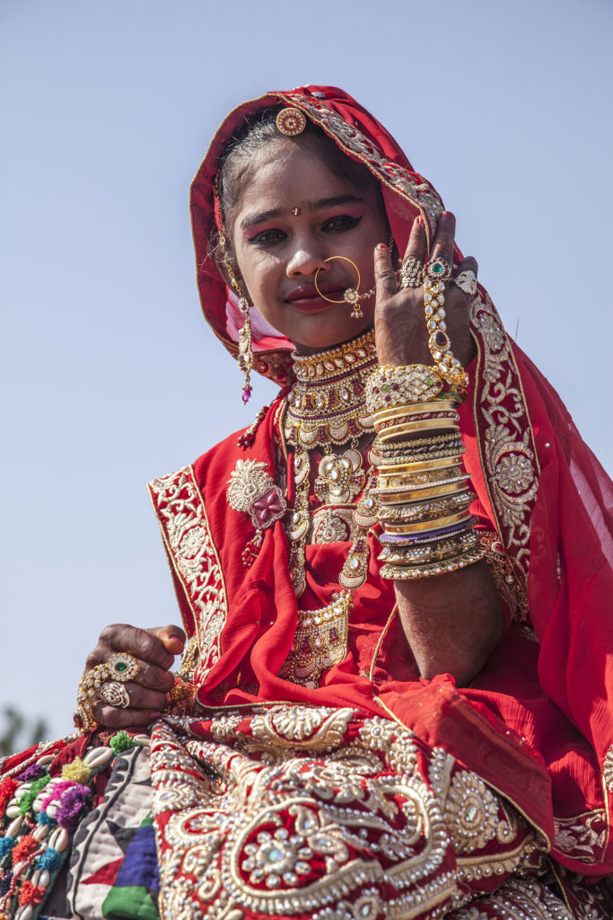 Young Indian woman with ornate decorations celebrating the Jaisalmer Desert Festival in India