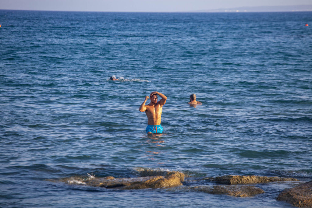 Man leaving sea at a beach in Limassol, Cyprus